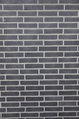 background consisting of vertical part of anthracite brick wall