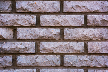 Decorative wall of rectangular bricks in concrete