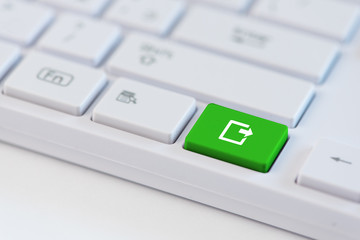 Export concepts. Green key with export icon on white laptop keyboard