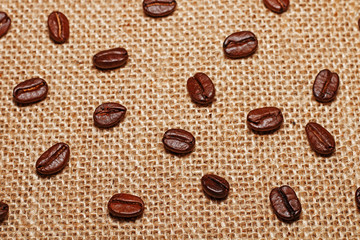 Grains of fried delicious and fragrant coffee on sack cloth.