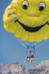 Two happy girls parasailing