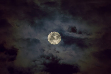 Naklejka na ściany i meble The full moon in the dark cloud.