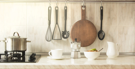 Kitchen concept fast cooking healthy breakfast. Cup of coffee and granola in bowl.