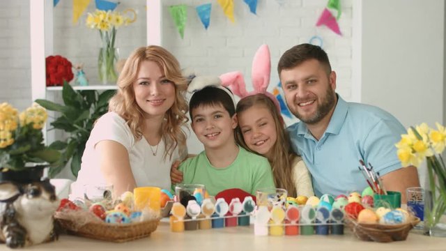 Portrait of happy friendly family with two children during Easter celebration