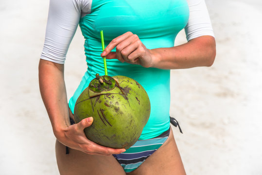 Green fresh coconut on woman hands