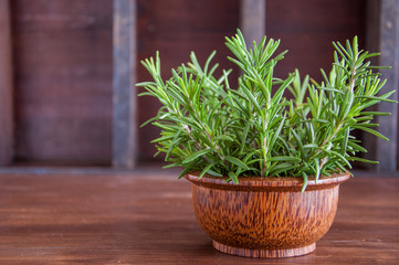 Fresh organic rosemary on a wooden background