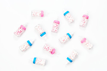 Decorative Baby milk bottles with candy. Decoration for Baby shower party. Flat lay, top view
