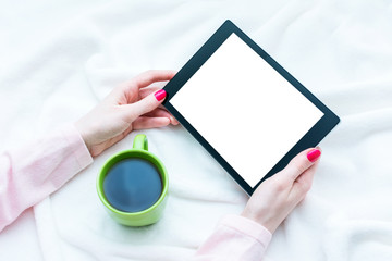 girl uses tablet pc, women's hands, lying on the blanket, white background with copy space, for advertising, top view