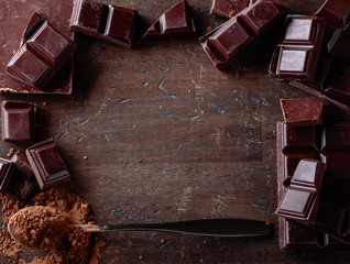 Broken  chocolate pieces and cocoa powder .