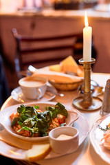 Table with delicious breakfast food near the window