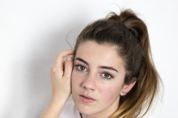 Obraz premium Studio portrait of a teenager. Vertical shot with natural light