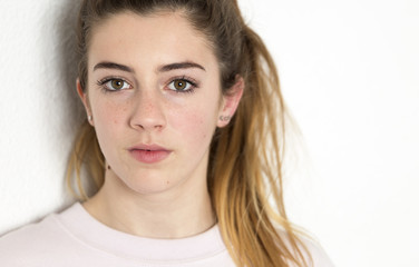 Portrait of a teenager looking at the camera. Vertical shot with natural light