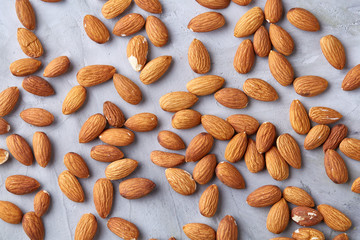 Seamless pattern with almond on the gray background, flat lay, close-up.