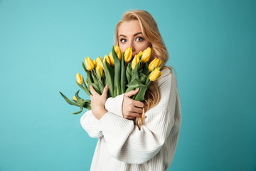 Portrait of a surprised young blonde woman in sweater