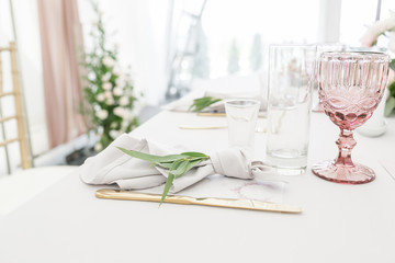 Beautiful table setting with crockery and flowers for a party, wedding reception or other festive...