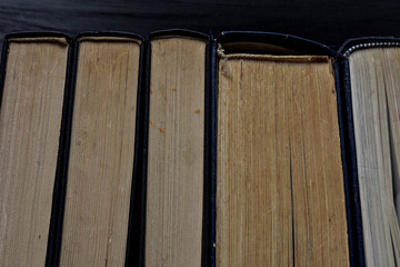 Stack of old dusty books viewed from the top