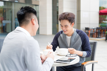 Two male student learning or entrepreneur working together.