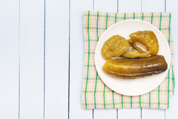 Tasty homemade snack from canned vegetables. Ingredients for salad on white plate.