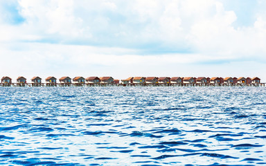 Water villas on tropical caribbean island, Maldives. Copy space for text