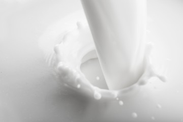 Fototapeta na wymiar Pouring white Milk