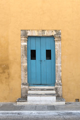 Fototapeta na wymiar Yellow house with blue wooden door in San Francisco de Campeche, Mexico