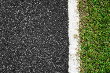 Fototapeta premium Asphalt road with white lines and green grass background.