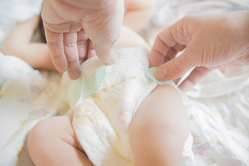 close-up of hands wearing baby diapers
