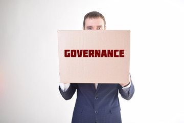 The businessman is holding a box with the inscription:GOVERNANCE