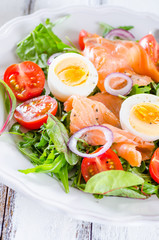 Smoked salmon salad with greens, tomatoes, eggs and avocado