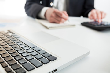 Obraz premium Close up view of bookkeeper or financial inspector hands making report, calculating or checking balance. Marketing strategy brainstorming. Paperwork and digital in office.