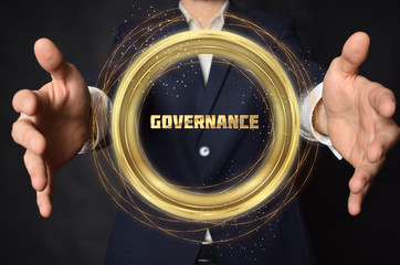 A businessman shows an inscription:GOVERNANCE