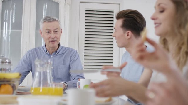 Family sat around the breakfast table one morning having a conversation