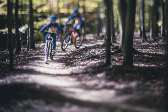 Tourists on sports trip concept, Ride new bike, Teaching cycling abstract background, Bike sports abstract  background, MTB for beginners, Single trail with young cyclist and his teacher 