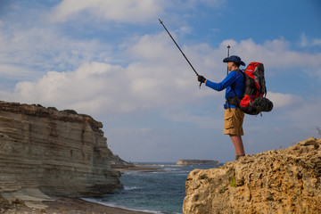 campaign with a backpack on with a tent

