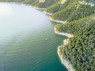 Aerial trees and cliff rock wall, bluffs at Lake Travis, Austin, Texas, USA. Luxury vacation homes...