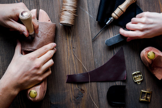 cobbler tools in workshop dark background top view