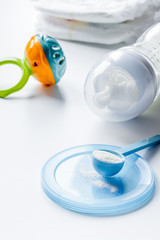 preparation of mixture baby feeding on white background