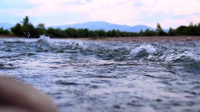 Wild mountain river with spring water stream. Stormy mountain river. Fast river flow. Fast water stream. Tranquil natural view. Mountain spring water