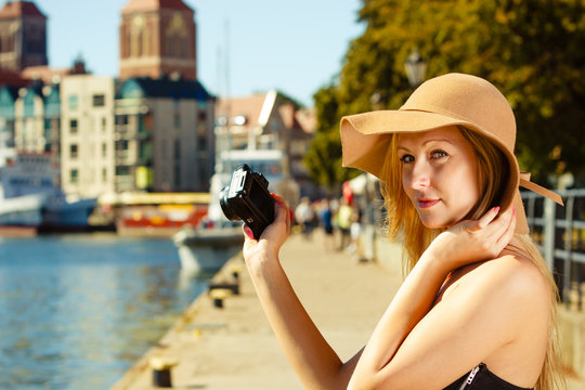 Beautiful elegant woman caught on taking pictures
