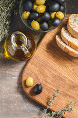 Glass bottle of olive oil with olives