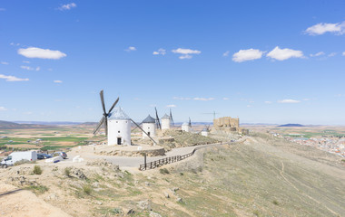 Tourism, Beautiful summer above the windmills on the field in Spain