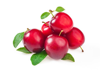 sweet ripe red plums with leaves, isolated on white background