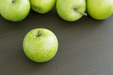 Fresh green apples on the table, close up.