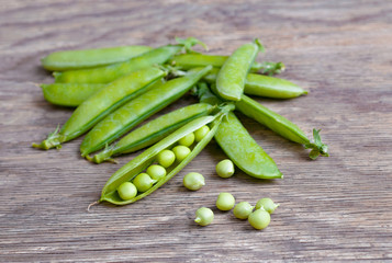 Green pea close-up view on rustic wooden background, natural wooden table