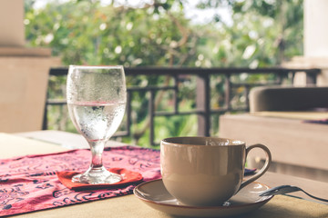 Glass of pure water on restaurant table outdoors. Bali island.