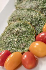 Spinach pancakes with cherry tomatoes. - 198473809