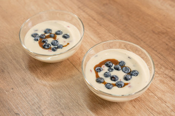 Vanilla pudding with blueberries and toffee sauce. - 198473894