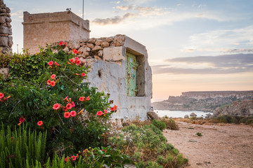 Beautiful golden sunset at Ghajn Tuffieha Tower, above Golden Bay, ancient watchtower built by the...