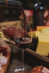 red wine being served in a bowl on a rustic table with accompaniments