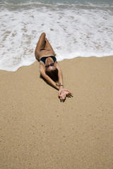 fashion photo of beautiful woman with dark hair and bright makeup on the beach, posing outdoor © Mariia Soloviova